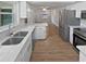 Modern kitchen with stainless steel appliances, sleek countertops, and an open view to the dining area at 2956 Laurel Ct, Dunedin, FL 34698