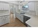 Modern kitchen showcasing white cabinets and stainless steel appliances at 2956 Laurel Ct, Dunedin, FL 34698