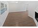 Bright living room featuring wood-look flooring and a charming fireplace at 2956 Laurel Ct, Dunedin, FL 34698