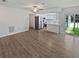 Open living area connecting to a modern kitchen and outdoor patio at 2956 Laurel Ct, Dunedin, FL 34698