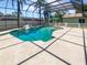 Gorgeous screened-in pool and spa with ample patio space, perfect for outdoor entertaining at 2956 Laurel Ct, Dunedin, FL 34698