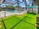 Screened-in pool and turf, showcasing a fenced-in oasis, perfect for relaxation and outdoor enjoyment at 2956 Laurel Ct, Dunedin, FL 34698