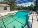 Sparkling pool with built-in spa and rock accents, creating a luxurious backyard experience at 2956 Laurel Ct, Dunedin, FL 34698