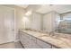 Bathroom with granite countertops, dual sinks, and large mirror at 14451 Coastal Woodland Ln, Parrish, FL 34219