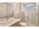 Bathroom featuring a glass-enclosed shower, modern vanity, and sleek fixtures at 14451 Coastal Woodland Ln, Parrish, FL 34219