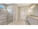 Modern bathroom featuring a glass shower enclosure, tiled walls, and vanity at 14451 Coastal Woodland Ln, Parrish, FL 34219