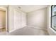 Bright bedroom features plush carpeting, a window for natural light, and a closet at 14451 Coastal Woodland Ln, Parrish, FL 34219