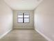 Bedroom with new flooring and a large window at 14451 Coastal Woodland Ln, Parrish, FL 34219