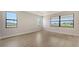 Bright, airy bedroom with large windows, offering plenty of natural light at 14451 Coastal Woodland Ln, Parrish, FL 34219