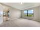 Light-filled bedroom with large windows and neutral decor at 14451 Coastal Woodland Ln, Parrish, FL 34219