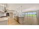 Spacious kitchen open to the living area, featuring stainless appliances and a large island at 14451 Coastal Woodland Ln, Parrish, FL 34219