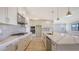 Bright, modern kitchen with stainless steel appliances, stone countertops, and ample cabinet space at 14451 Coastal Woodland Ln, Parrish, FL 34219