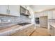 Modern kitchen features grey subway tile backsplash, stainless steel appliances, and ample cabinet space at 14451 Coastal Woodland Ln, Parrish, FL 34219