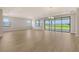 Living room with sliding glass door and lots of natural light at 14451 Coastal Woodland Ln, Parrish, FL 34219