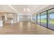 Bright, open-concept living room featuring hardwood floors and sliding glass doors at 14451 Coastal Woodland Ln, Parrish, FL 34219
