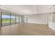 Open living space with hardwood floors and sliding doors to the outdoor patio and backyard at 14451 Coastal Woodland Ln, Parrish, FL 34219