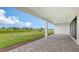 Outdoor patio with brick flooring and picturesque views of green lawn at 14451 Coastal Woodland Ln, Parrish, FL 34219