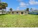 Expansive backyard featuring a well-maintained lawn and a view of the home's exterior at 3593 Junction St, North Port, FL 34288