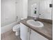 Bathroom featuring a vanity with countertop sink and a tub with tile surround at 3593 Junction St, North Port, FL 34288