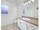 Bright bathroom featuring white cabinetry, neutral countertop, and ample lighting at 3593 Junction St, North Port, FL 34288