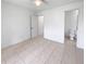 This is an airy bedroom with tiled floors, white walls and ceilings, with an attached bathroom at 3593 Junction St, North Port, FL 34288