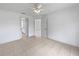 This bright bedroom boasts tiled floors, ceiling fan, and two doors leading to other areas at 3593 Junction St, North Port, FL 34288