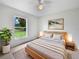 Cozy bedroom with soft lighting, neutral bedding, and a view of the outdoors at 3593 Junction St, North Port, FL 34288