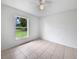 Simple bedroom with tile floor, natural light and a view of the outdoors at 3593 Junction St, North Port, FL 34288