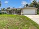 Charming single-story home featuring a two-car garage and well-maintained front yard at 3593 Junction St, North Port, FL 34288