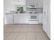 Bright kitchen featuring white appliances, countertops, and ample cabinet space at 3593 Junction St, North Port, FL 34288