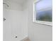 Clean white stand-up shower with window providing natural light at 3593 Junction St, North Port, FL 34288