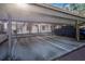 Assigned covered parking space in condo carport area, with mature manicured landscaping at 11511 113Th St # 13F, Seminole, FL 33778