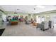Community clubhouse with a pool table, bookshelves, and seating areas for residents to socialize and relax at 11511 113Th St # 13F, Seminole, FL 33778
