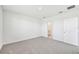 A bedroom featuring neutral carpet, light walls, and an adjoining bathroom at 14068 Crutchfield Ct, Parrish, FL 34219