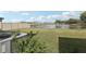 Backyard with a lake view surrounded by a fence and lush greenery, enhanced by a view of the community at 2318 E Newsome Rd, Plant City, FL 33565
