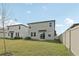 Backyard featuring a manicured lawn and modern home architecture at 2318 E Newsome Rd, Plant City, FL 33565