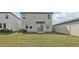 Expansive backyard featuring a well-maintained lawn, patio, and the home's back facade at 2318 E Newsome Rd, Plant City, FL 33565