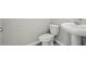 Cozy bathroom with a white toilet and pedestal sink at 2318 E Newsome Rd, Plant City, FL 33565