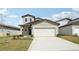 Charming two-story home featuring a two-car garage, neutral siding, and well-maintained landscaping at 2318 E Newsome Rd, Plant City, FL 33565