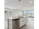 Kitchen island featuring a stainless dishwasher and granite countertops at 2318 E Newsome Rd, Plant City, FL 33565