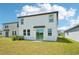 Backyard view of a two-story home with sliding glass doors at 3912 Radiant Mountain Dr, Plant City, FL 33565