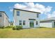 Exterior rear view of a two-story home with a lawn at 3912 Radiant Mountain Dr, Plant City, FL 33565