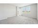 Well-lit bedroom features soft carpet and three windows at 3912 Radiant Mountain Dr, Plant City, FL 33565