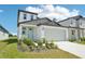 Beautifully landscaped two-story home with a two-car garage and well-manicured lawn at 3912 Radiant Mountain Dr, Plant City, FL 33565