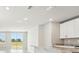 Modern kitchen with sleek countertops, ample cabinet space, and scenic backyard views at 3912 Radiant Mountain Dr, Plant City, FL 33565