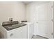 Convenient laundry room with modern washer and dryer units and easy access to the rest of the home at 3912 Radiant Mountain Dr, Plant City, FL 33565