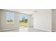 Bright living room with tile floors, backyard views, and access to the patio at 3912 Radiant Mountain Dr, Plant City, FL 33565
