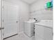 Well-equipped laundry room with a washer, dryer, and ample storage space at 13327 Willow Bluestar Loop, Riverview, FL 33579