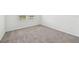 Bedroom with gray carpet flooring, a window and lots of light at 225 Lazy Shore Dr, Nokomis, FL 34275