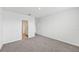A neutral colored bedroom with carpet flooring and an open doorway at 225 Lazy Shore Dr, Nokomis, FL 34275